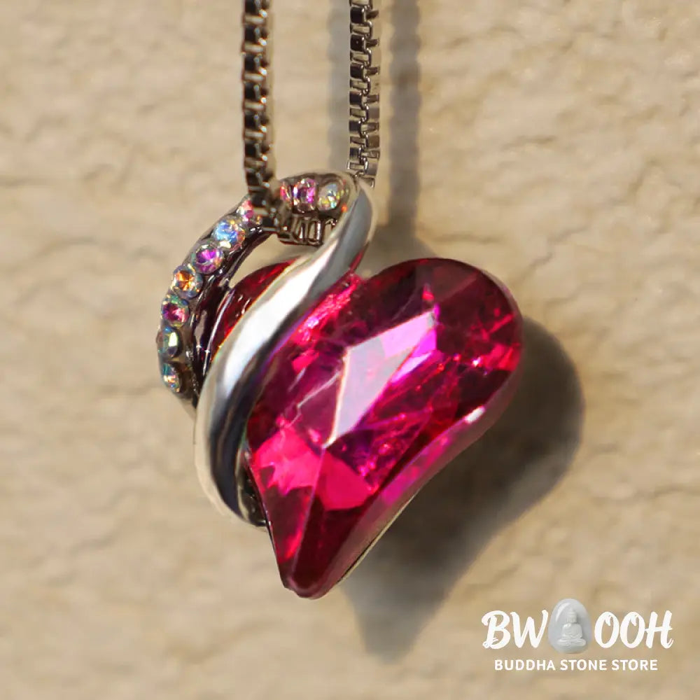 A BWOOOH Love Heart Birthstone Necklace pendant featuring a vibrant, wild-heart-shaped premium crystal, elegantly embraced by a silver-tone ribbon forming an infinity symbol, symbolizing triumph of love and eternal spiritual connection. - View 10