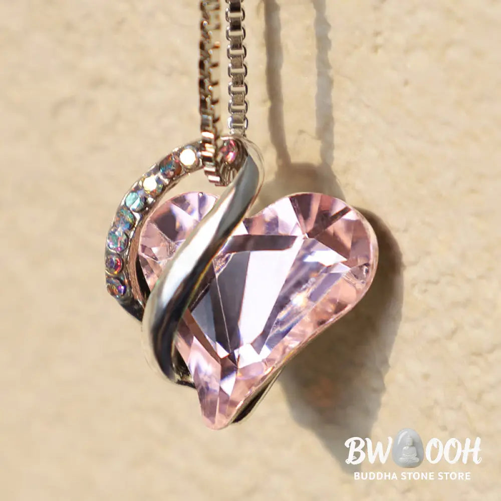 A BWOOOH Love Heart Birthstone Necklace pendant featuring a vibrant, wild-heart-shaped premium crystal, elegantly embraced by a silver-tone ribbon forming an infinity symbol, symbolizing triumph of love and eternal spiritual connection. - View 37
