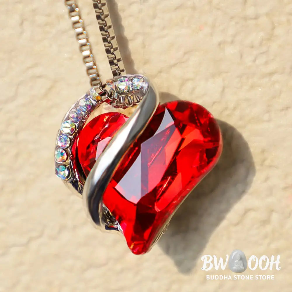 A BWOOOH Love Heart Birthstone Necklace pendant featuring a vibrant, wild-heart-shaped premium crystal, elegantly embraced by a silver-tone ribbon forming an infinity symbol, symbolizing triumph of love and eternal spiritual connection. - View 4