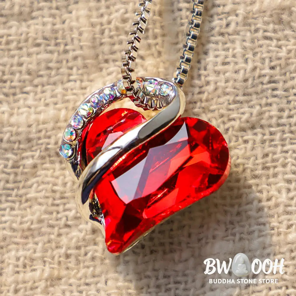 A BWOOOH Love Heart Birthstone Necklace pendant featuring a vibrant, wild-heart-shaped premium crystal, elegantly embraced by a silver-tone ribbon forming an infinity symbol, symbolizing triumph of love and eternal spiritual connection. - View 2