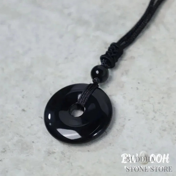 A BWOOOH Lucky Coin Pendant Necklace featuring a round, polished gemstone pendant, approximately 1.18 inches in diameter, suspended on a 26-inch chain, showcasing materials such as Green Aventurine, Pink Crystal, Black Onyx, and Jade, designed for spiritual wellness and good fortune. - View 16