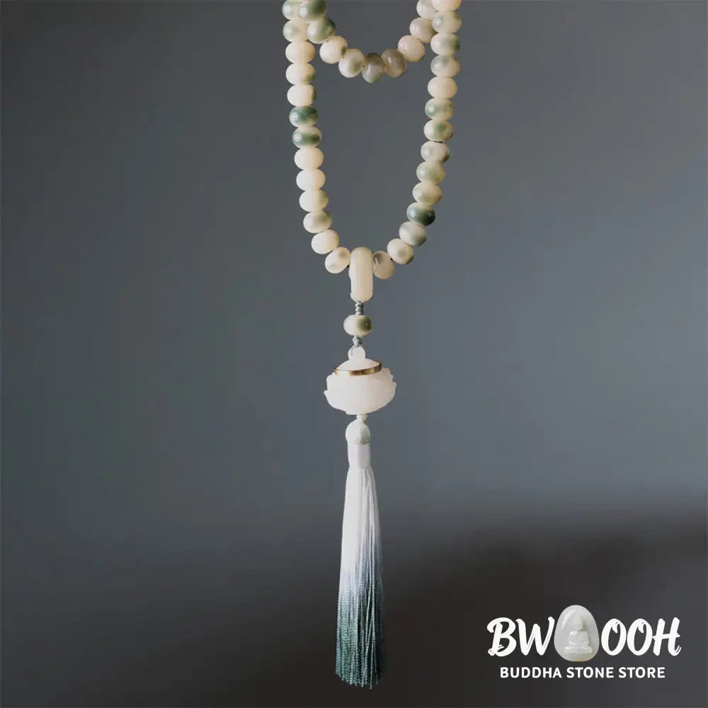 BWOOOH Natural 108 Bodhi Seed Mala Bracelet with carved lotus, luminous stone accents, and a wisdom tassel, displayed against a serene backdrop, ready for mindful practice. - View 6