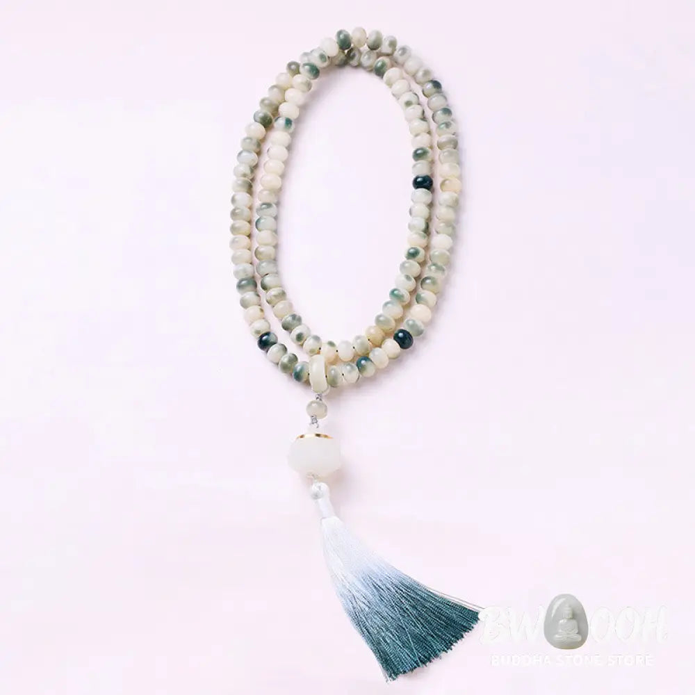 BWOOOH Natural 108 Bodhi Seed Mala Bracelet with carved lotus, luminous stone accents, and a wisdom tassel, displayed against a serene backdrop, ready for mindful practice. - View 4