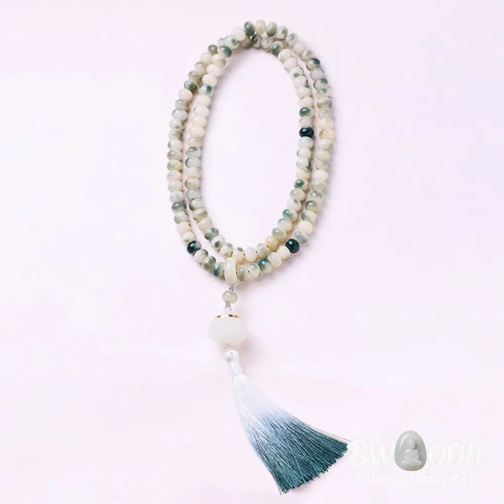 BWOOOH Natural 108 Bodhi Seed Mala Bracelet with carved lotus, luminous stone accents, and a wisdom tassel, displayed against a serene backdrop, ready for mindful practice. - View 4