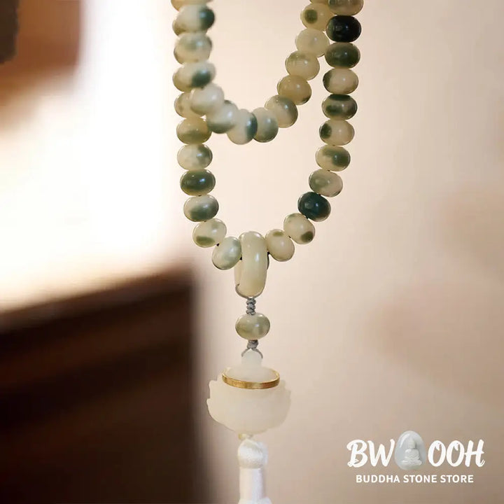BWOOOH Natural 108 Bodhi Seed Mala Bracelet with carved lotus, luminous stone accents, and a wisdom tassel, displayed against a serene backdrop, ready for mindful practice. - View 3