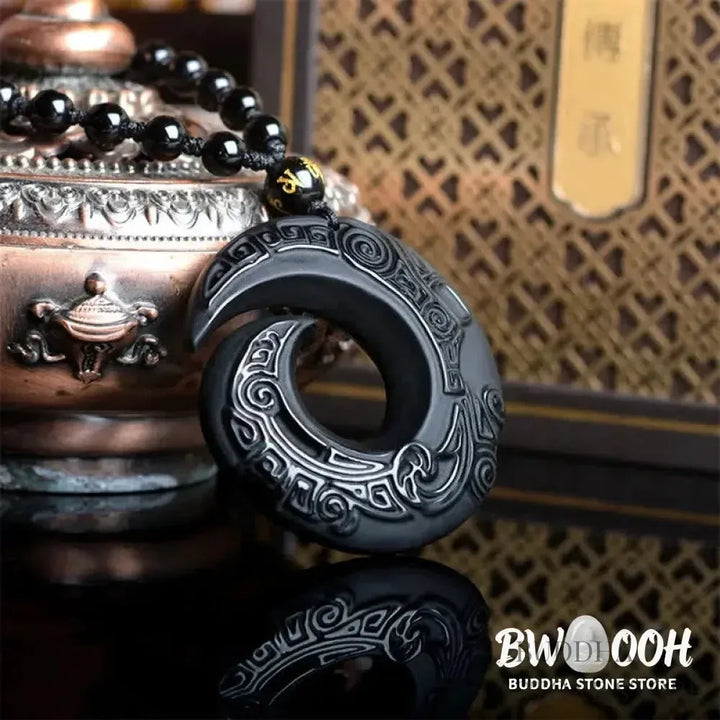BWOOOH Natural Black Obsidian and Ice Obsidian Peace Buckle Strength Necklace Pendant, showcasing a polished black obsidian stone adjacent to a translucent ice obsidian peace buckle on an adjustable cord. - View 3