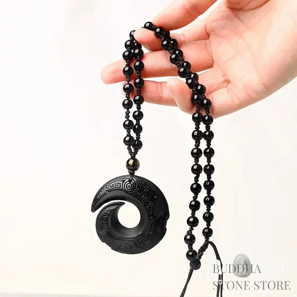 BWOOOH Natural Black Obsidian and Ice Obsidian Peace Buckle Strength Necklace Pendant, showcasing a polished black obsidian stone adjacent to a translucent ice obsidian peace buckle on an adjustable cord. - View 6