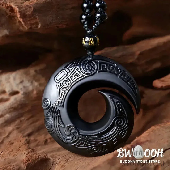 BWOOOH Natural Black Obsidian and Ice Obsidian Peace Buckle Strength Necklace Pendant, showcasing a polished black obsidian stone adjacent to a translucent ice obsidian peace buckle on an adjustable cord. - View 5