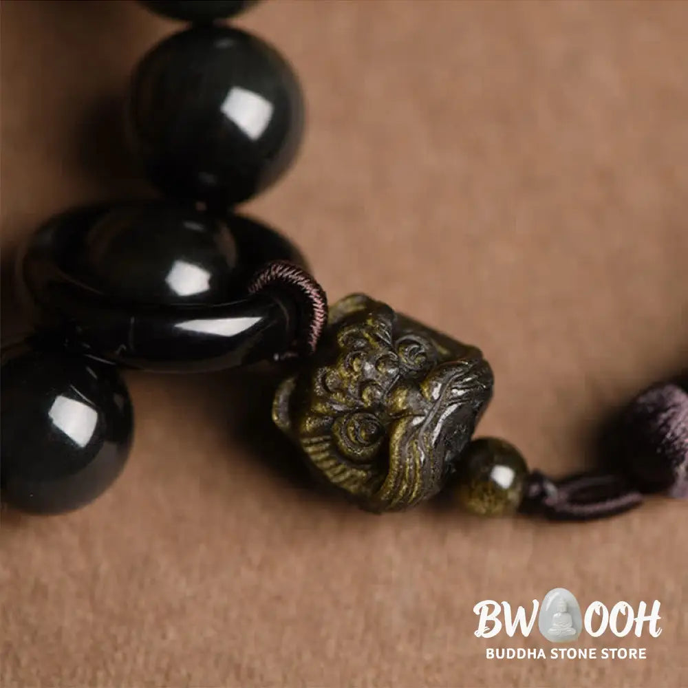 A BWOOOH Natural Black Obsidian Lion Wrist Mala with protection tassels, shown as a pocket mala and car decoration, embodying courage, wisdom, and spiritual enlightenment for energetic protection and positive Feng Shui. - View 5