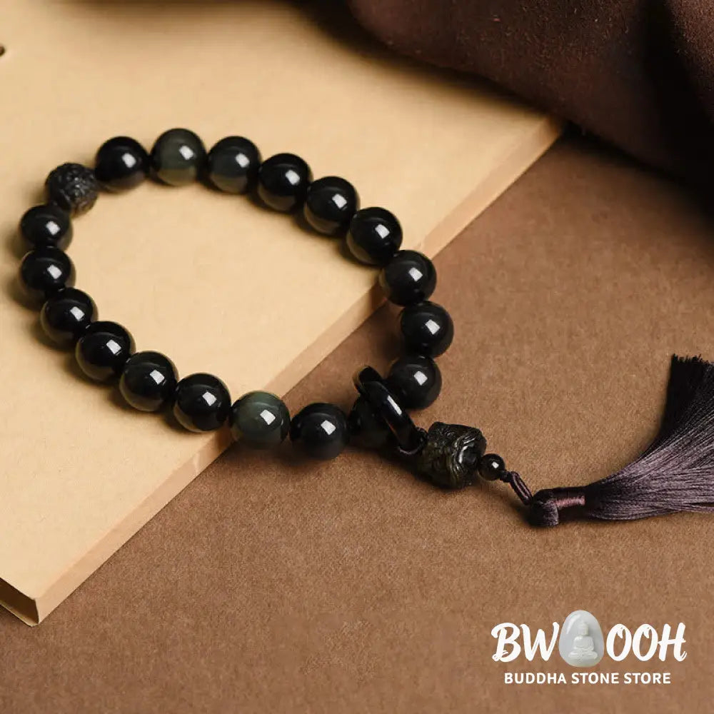 A BWOOOH Natural Black Obsidian Lion Wrist Mala with protection tassels, shown as a pocket mala and car decoration, embodying courage, wisdom, and spiritual enlightenment for energetic protection and positive Feng Shui. - View 2