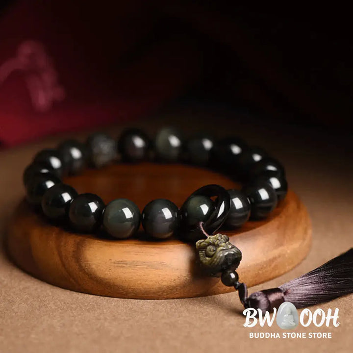 A BWOOOH Natural Black Obsidian Lion Wrist Mala with protection tassels, shown as a pocket mala and car decoration, embodying courage, wisdom, and spiritual enlightenment for energetic protection and positive Feng Shui. - View 6