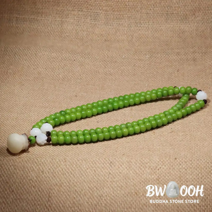 Close-up of BWOOOH Natural Bodhi Seed 108 Beads Mala Wisdom Bracelet, featuring dark-speckled 6mmx8mm seeds, symbolizing enlightenment and spiritual awakening, elegantly wrapped around a wrist for meditation. - View 3