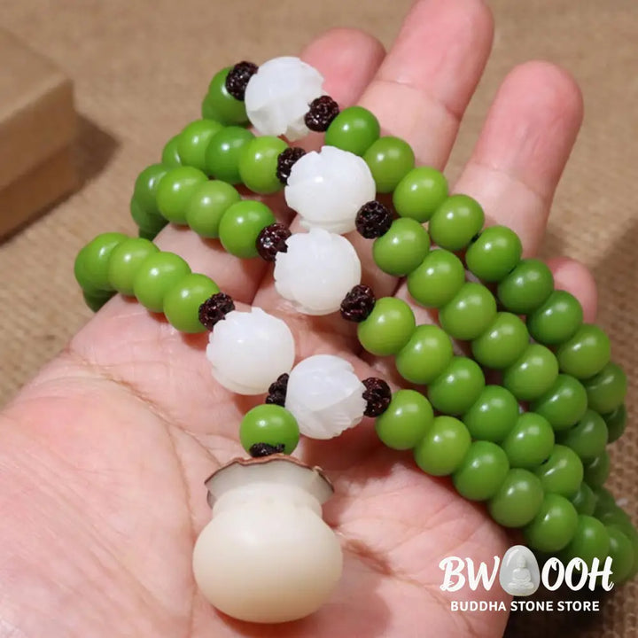 Close-up of BWOOOH Natural Bodhi Seed 108 Beads Mala Wisdom Bracelet, featuring dark-speckled 6mmx8mm seeds, symbolizing enlightenment and spiritual awakening, elegantly wrapped around a wrist for meditation. - View 4