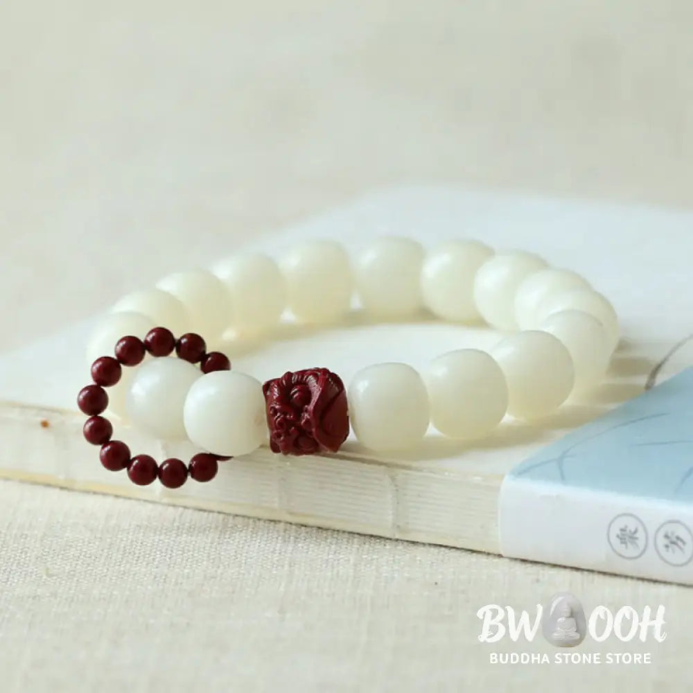 Close-up of BWOOOH Natural Bodhi Seed Wrist Mala with vibrant red Cinnabar beads and a detailed Dancing Lion charm on an elastic string, symbolizing wisdom, harmony, and protection during meditation practices. - View 2