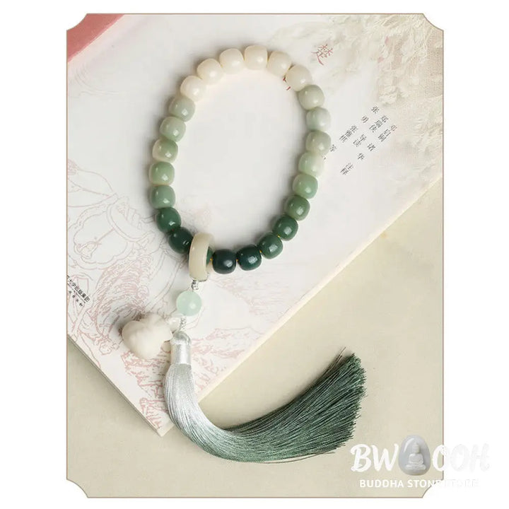 BWOOOH Natural Gradient Bodhi Seed Fortune Money Bag Lotus Wisdom Tassel Wrist Mala featuring 12mm dark-speckled bodhi seeds, boxwood, agate, and green aventurine; a handcrafted spiritual meditation bracelet for wisdom and calm. - View 5