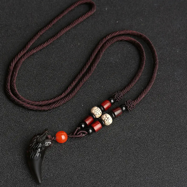 BWOOOH Natural Ice Obsidian Wolf Tooth Pattern Courage Necklace Pendant, available in unisex large (63*14mm) and small (41*14mm) sizes. A striking natural stone pendant for energy protection and strength. - View 9