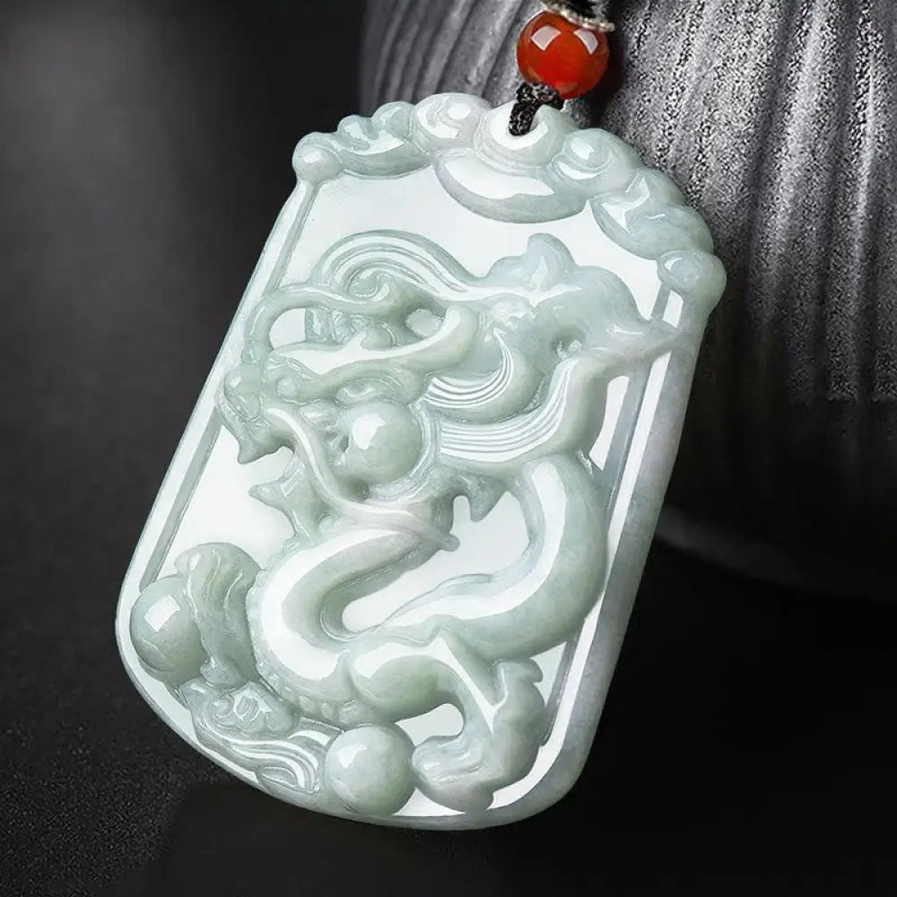 A BWOOOH Natural Jade 12 Chinese Zodiac Abundance Amulet Pendant Necklace, featuring intricate carvings of animals like the Dragon and Tiger, symbolizing prosperity and spiritual balance. The jade stone is polished, reflecting light and emphasizing its natural beauty.