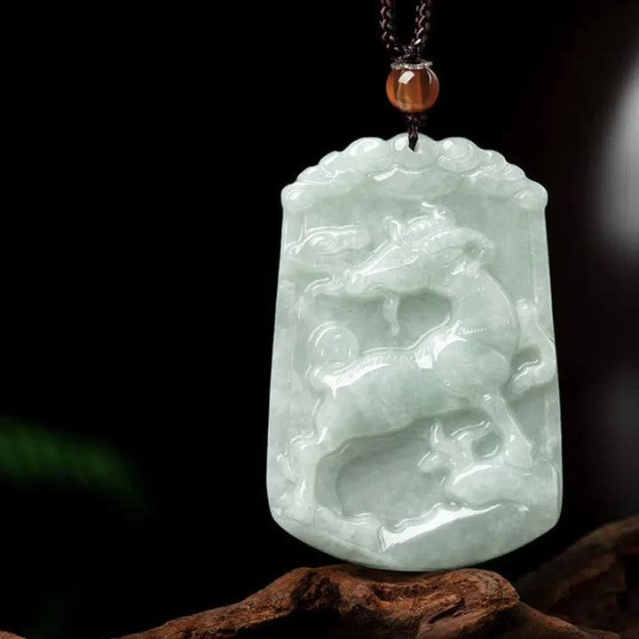 A BWOOOH Natural Jade 12 Chinese Zodiac Abundance Amulet Pendant Necklace, featuring intricate carvings of animals like the Dragon and Tiger, symbolizing prosperity and spiritual balance. The jade stone is polished, reflecting light and emphasizing its natural beauty. - View 21