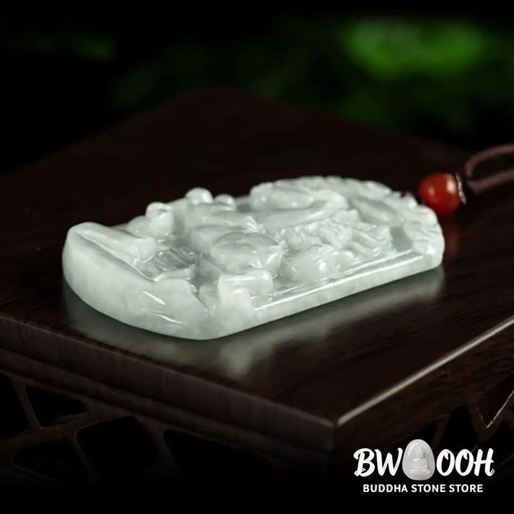 A BWOOOH Natural Jade 12 Chinese Zodiac Abundance Amulet Pendant Necklace, featuring intricate carvings of animals like the Dragon and Tiger, symbolizing prosperity and spiritual balance. The jade stone is polished, reflecting light and emphasizing its natural beauty. - View 10