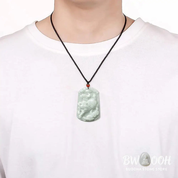 A BWOOOH Natural Jade 12 Chinese Zodiac Abundance Amulet Pendant Necklace, featuring intricate carvings of animals like the Dragon and Tiger, symbolizing prosperity and spiritual balance. The jade stone is polished, reflecting light and emphasizing its natural beauty. - View 14