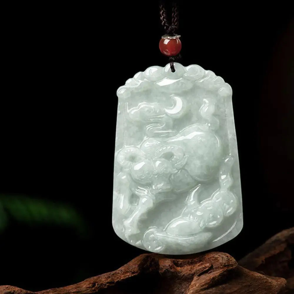 A BWOOOH Natural Jade 12 Chinese Zodiac Abundance Amulet Pendant Necklace, featuring intricate carvings of animals like the Dragon and Tiger, symbolizing prosperity and spiritual balance. The jade stone is polished, reflecting light and emphasizing its natural beauty. - View 12