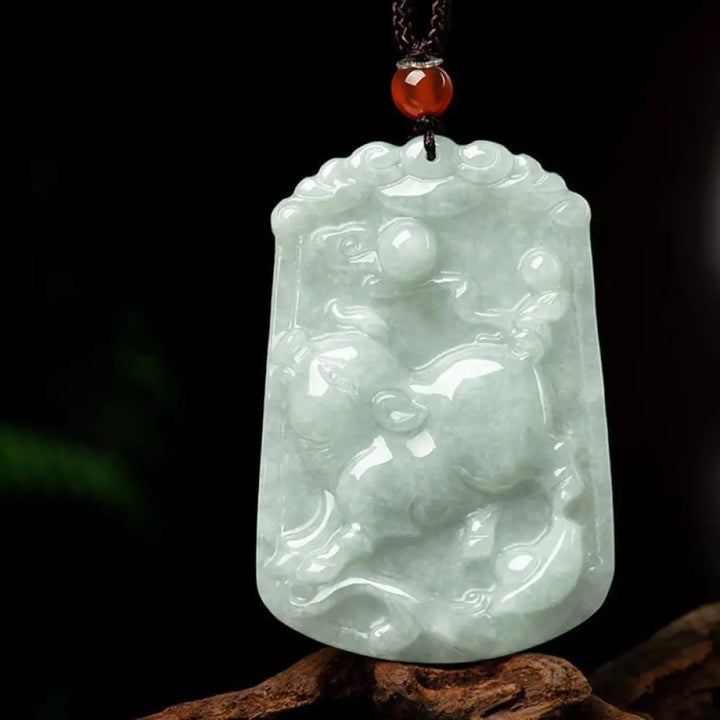 A BWOOOH Natural Jade 12 Chinese Zodiac Abundance Amulet Pendant Necklace, featuring intricate carvings of animals like the Dragon and Tiger, symbolizing prosperity and spiritual balance. The jade stone is polished, reflecting light and emphasizing its natural beauty. - View 25