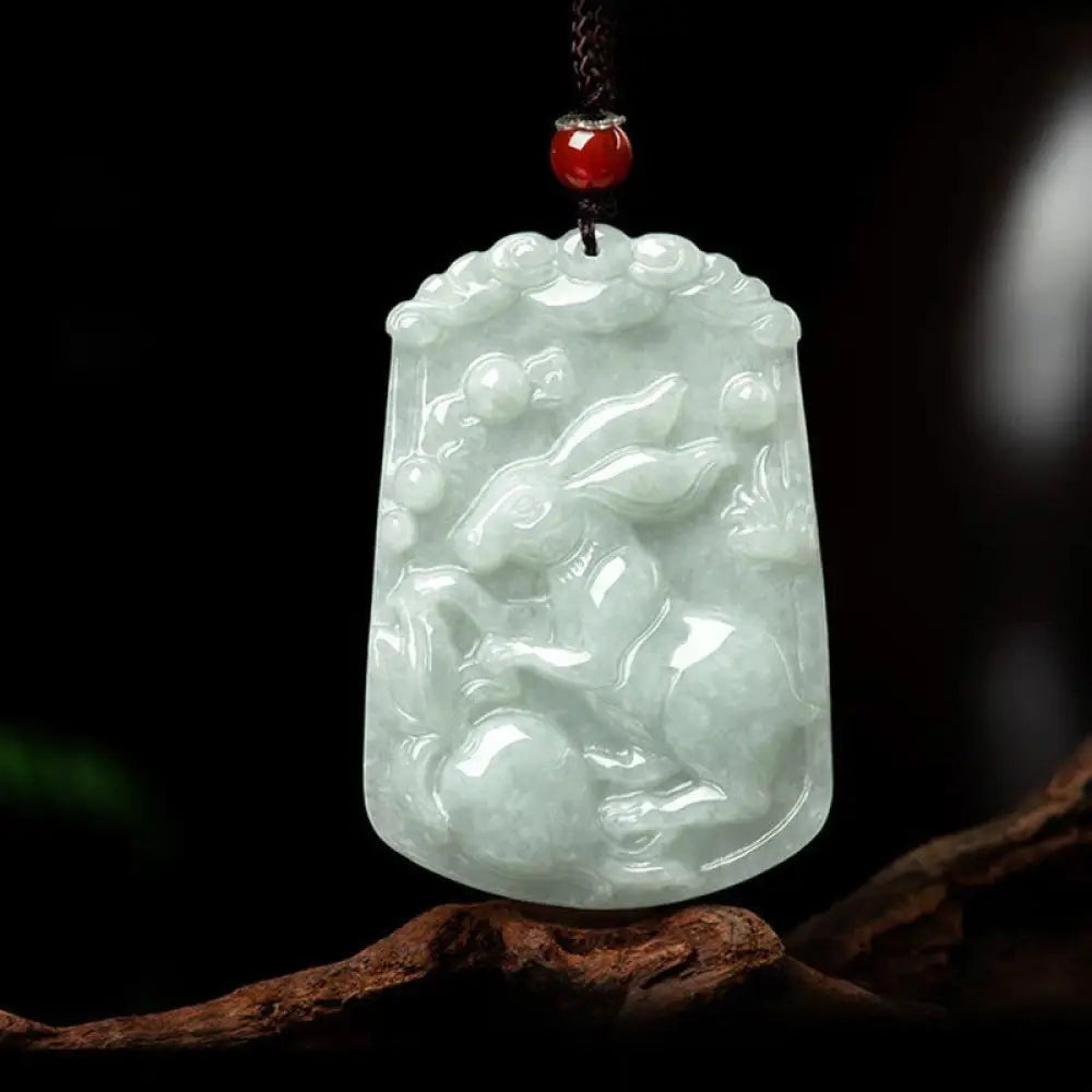 A BWOOOH Natural Jade 12 Chinese Zodiac Abundance Amulet Pendant Necklace, featuring intricate carvings of animals like the Dragon and Tiger, symbolizing prosperity and spiritual balance. The jade stone is polished, reflecting light and emphasizing its natural beauty. - View 16