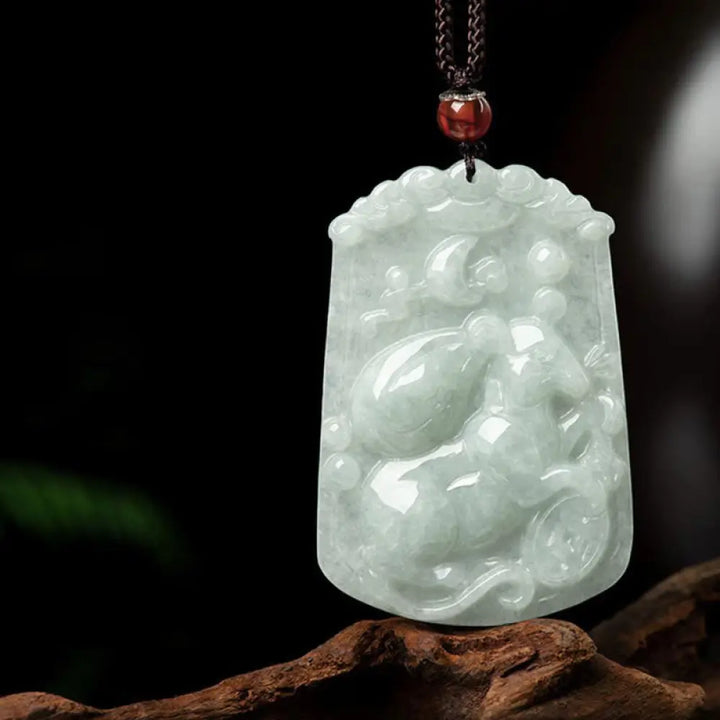 A BWOOOH Natural Jade 12 Chinese Zodiac Abundance Amulet Pendant Necklace, featuring intricate carvings of animals like the Dragon and Tiger, symbolizing prosperity and spiritual balance. The jade stone is polished, reflecting light and emphasizing its natural beauty. - View 11