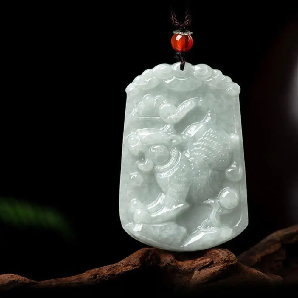 A BWOOOH Natural Jade 12 Chinese Zodiac Abundance Amulet Pendant Necklace, featuring intricate carvings of animals like the Dragon and Tiger, symbolizing prosperity and spiritual balance. The jade stone is polished, reflecting light and emphasizing its natural beauty. - View 15