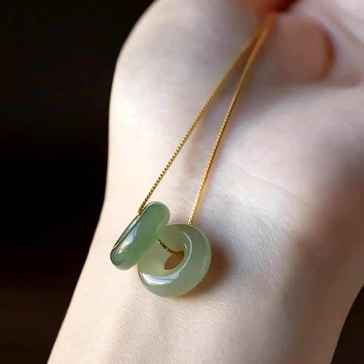 BWOOOH Natural Round Jade Peace Buckle Necklace featuring a polished green Jade disc, 40cm 925 sterling silver plated gold chain, symbolizing luck and abundance.