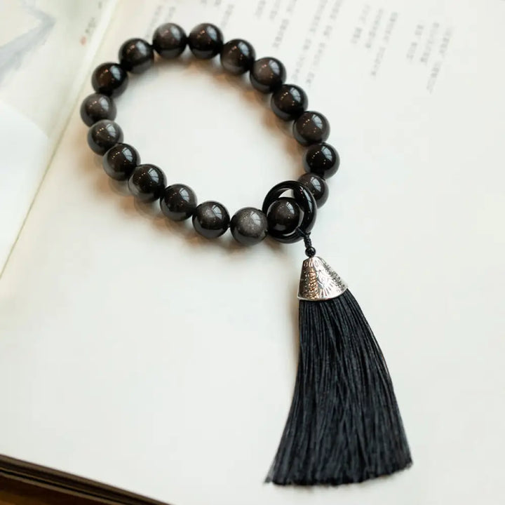 BWOOOH Natural Silver Sheen Obsidian and Black Obsidian Lion Wrist Mala with Tassels. 14mm/16mm beads, 16*15*15mm lion, for protection, courage, and positive Feng Shui energy. - View 4