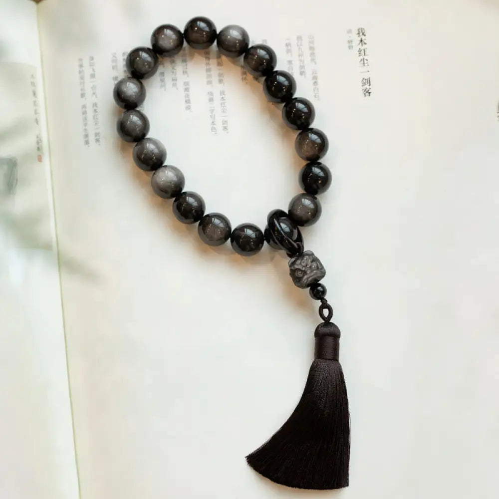 BWOOOH Natural Silver Sheen Obsidian and Black Obsidian Lion Wrist Mala with Tassels. 14mm/16mm beads, 16*15*15mm lion, for protection, courage, and positive Feng Shui energy. - View 6