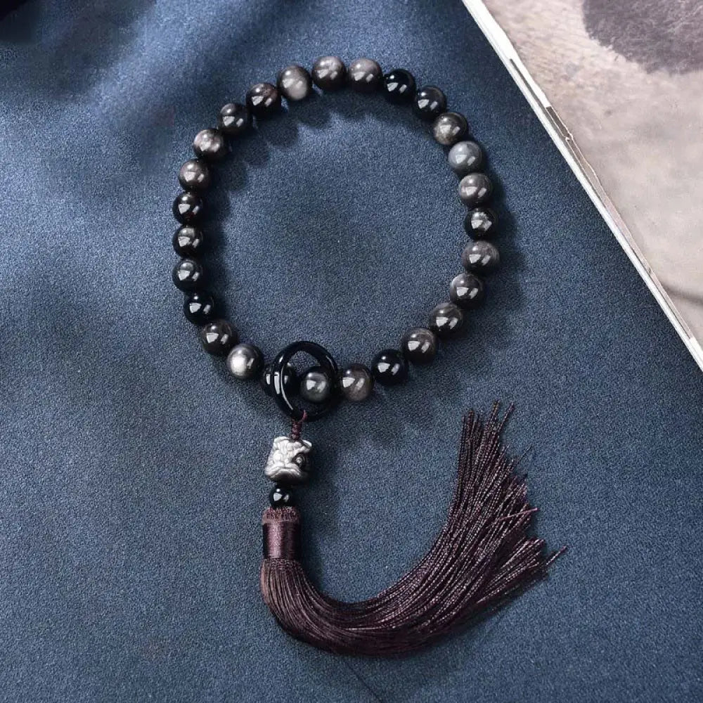 BWOOOH Silver Sheen Obsidian Lion Wrist Mala, polished beads (12-16mm), carved lion, tassels. Offers energetic protection, also a pocket mala or car decoration.