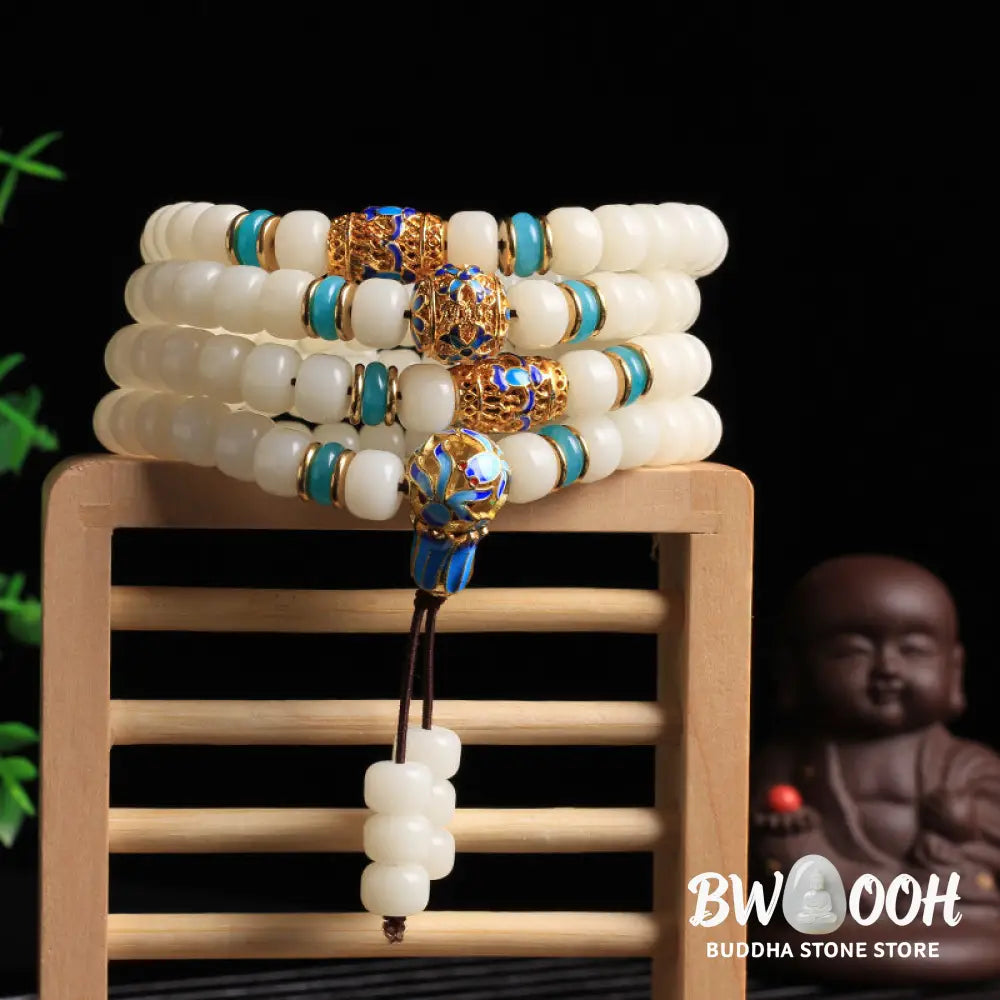 A BWOOOH Natural White Bodhi Seed Mala bracelet, featuring 108 dark-speckled beads, handmade for meditation, spiritual wisdom, and attracting wealth. Unisex design, worn on wrist. - View 2