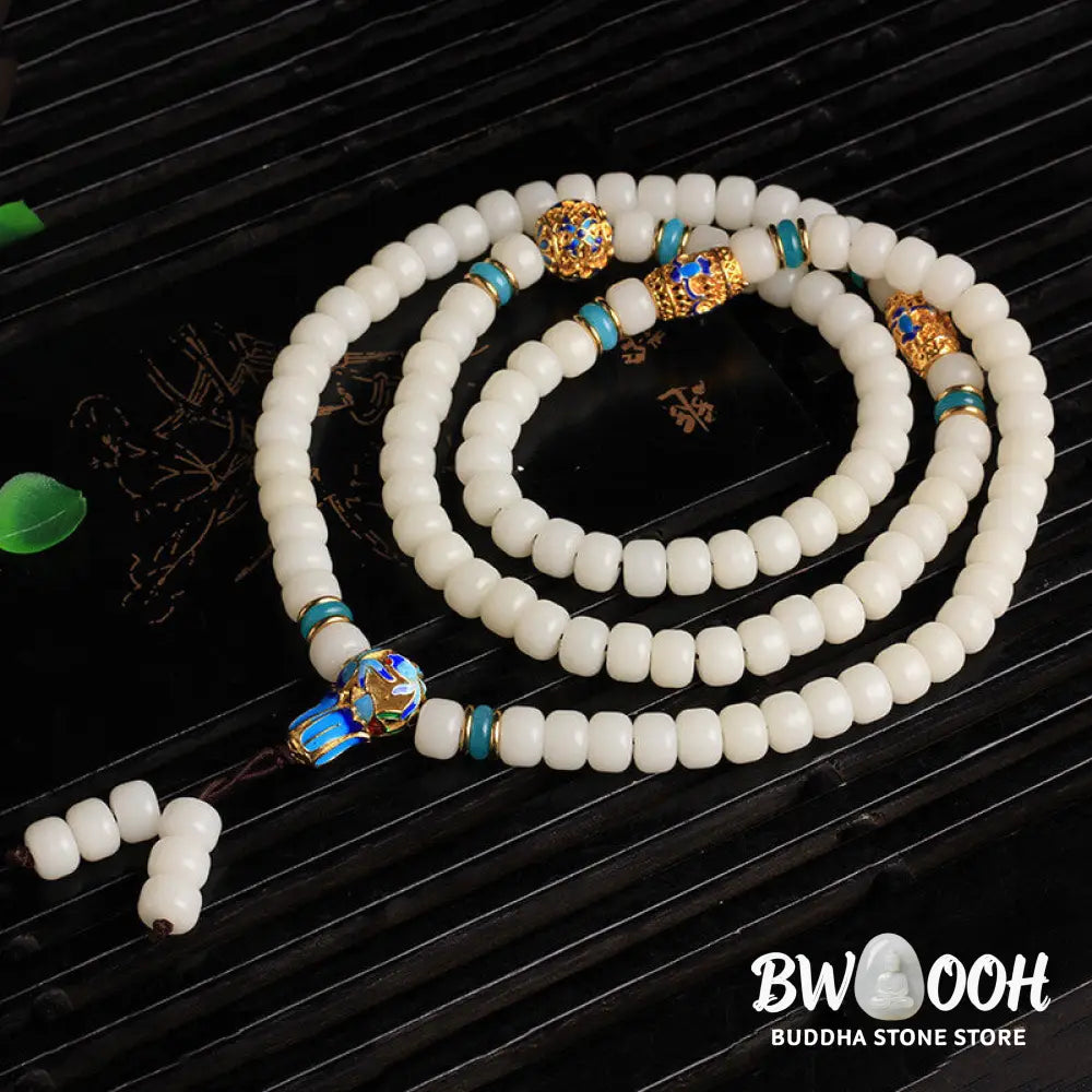 A BWOOOH Natural White Bodhi Seed Mala bracelet, featuring 108 dark-speckled beads, handmade for meditation, spiritual wisdom, and attracting wealth. Unisex design, worn on wrist. - View 3
