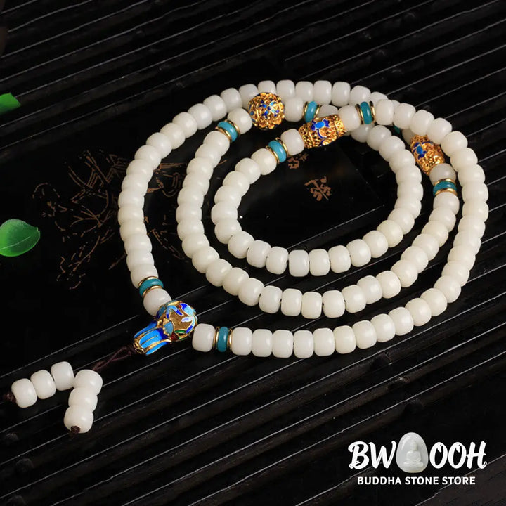 A BWOOOH Natural White Bodhi Seed Mala bracelet, featuring 108 dark-speckled beads, handmade for meditation, spiritual wisdom, and attracting wealth. Unisex design, worn on wrist. - View 3