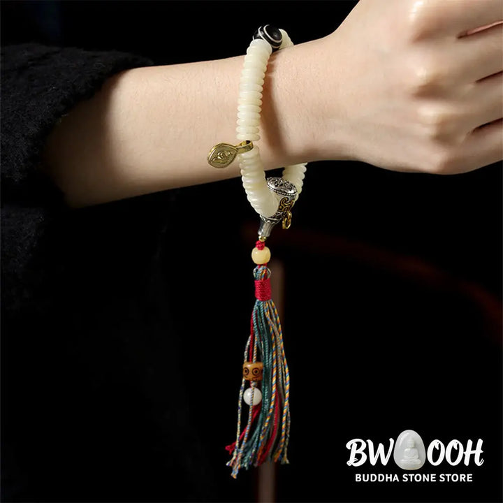 BWOOOH Natural White Bodhi Seed Wisdom Tassel Wrist Mala Bracelet, featuring dark-speckled Bodhi seeds (3x10mm) with a white copper accent and soft tassel, on a 14-15cm elastic string. Ideal for meditation and spiritual balance. - View 11