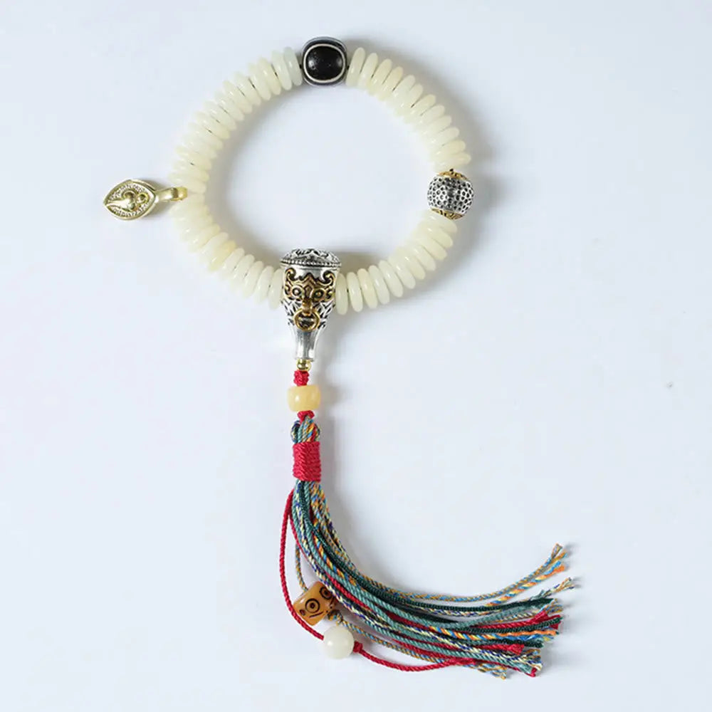 BWOOOH Natural White Bodhi Seed Wisdom Tassel Wrist Mala Bracelet, featuring dark-speckled Bodhi seeds (3x10mm) with a white copper accent and soft tassel, on a 14-15cm elastic string. Ideal for meditation and spiritual balance. - View 9