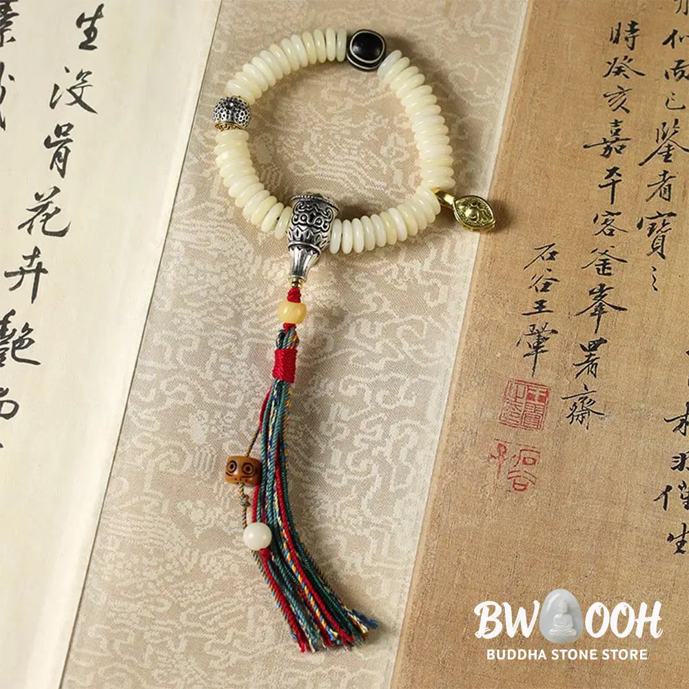 BWOOOH Natural White Bodhi Seed Wisdom Tassel Wrist Mala Bracelet, featuring dark-speckled Bodhi seeds (3x10mm) with a white copper accent and soft tassel, on a 14-15cm elastic string. Ideal for meditation and spiritual balance. - View 10