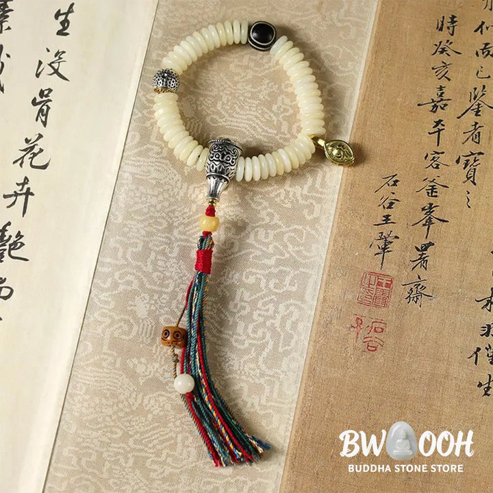 BWOOOH Natural White Bodhi Seed Wisdom Tassel Wrist Mala Bracelet, featuring dark-speckled Bodhi seeds (3x10mm) with a white copper accent and soft tassel, on a 14-15cm elastic string. Ideal for meditation and spiritual balance. - View 10