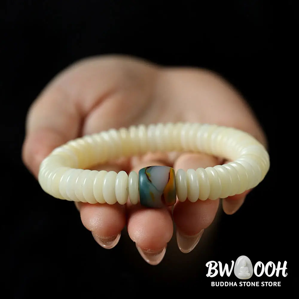 BWOOOH Natural White Bodhi Seed Wisdom Tassel Wrist Mala Bracelet, featuring dark-speckled Bodhi seeds (3x10mm) with a white copper accent and soft tassel, on a 14-15cm elastic string. Ideal for meditation and spiritual balance. - View 3