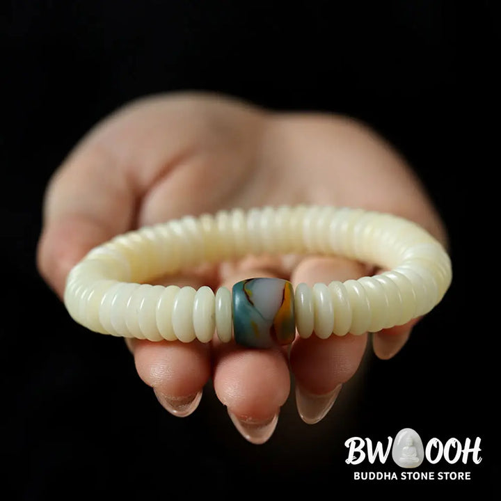 BWOOOH Natural White Bodhi Seed Wisdom Tassel Wrist Mala Bracelet, featuring dark-speckled Bodhi seeds (3x10mm) with a white copper accent and soft tassel, on a 14-15cm elastic string. Ideal for meditation and spiritual balance. - View 3