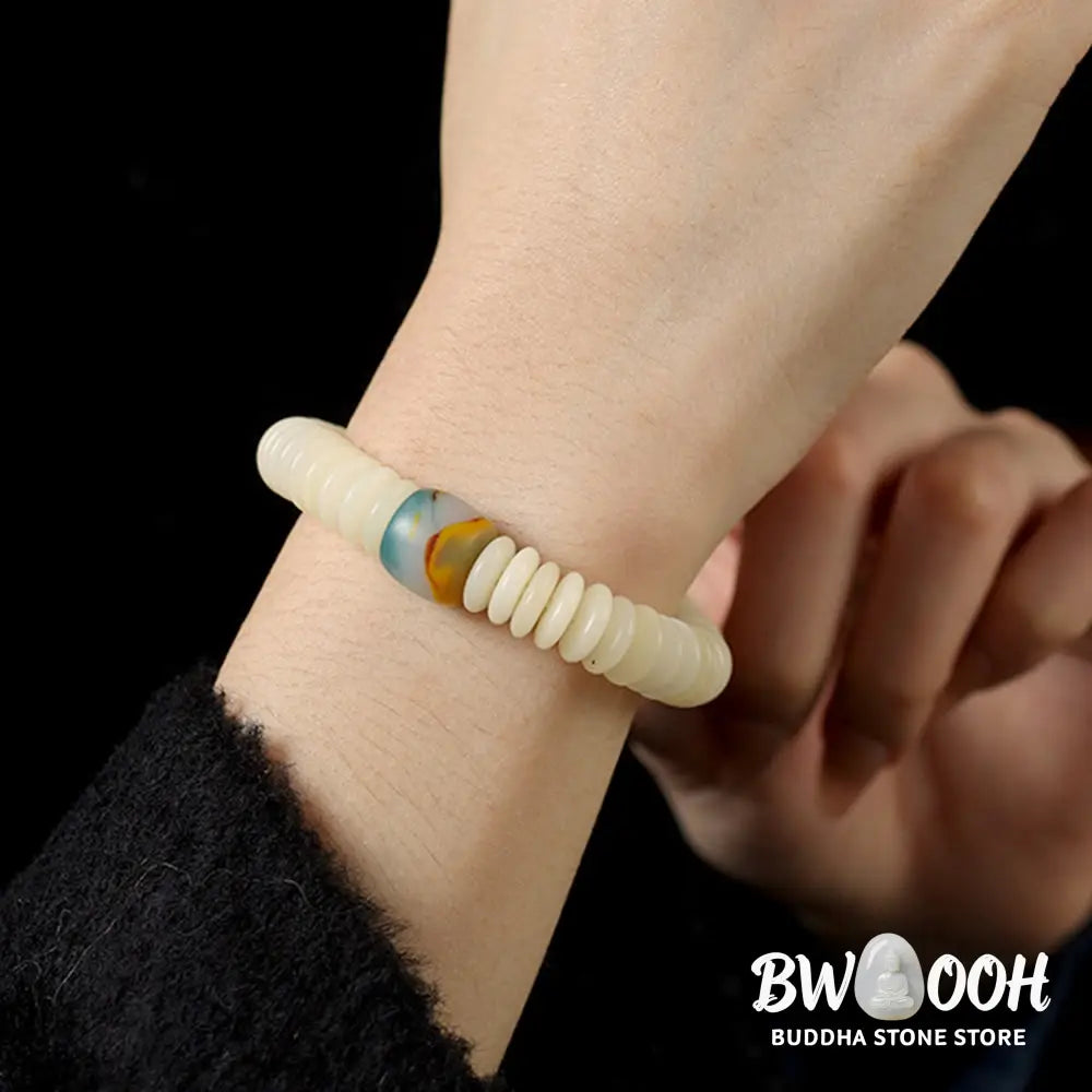 BWOOOH Natural White Bodhi Seed Wisdom Tassel Wrist Mala Bracelet, featuring dark-speckled Bodhi seeds (3x10mm) with a white copper accent and soft tassel, on a 14-15cm elastic string. Ideal for meditation and spiritual balance. - View 5