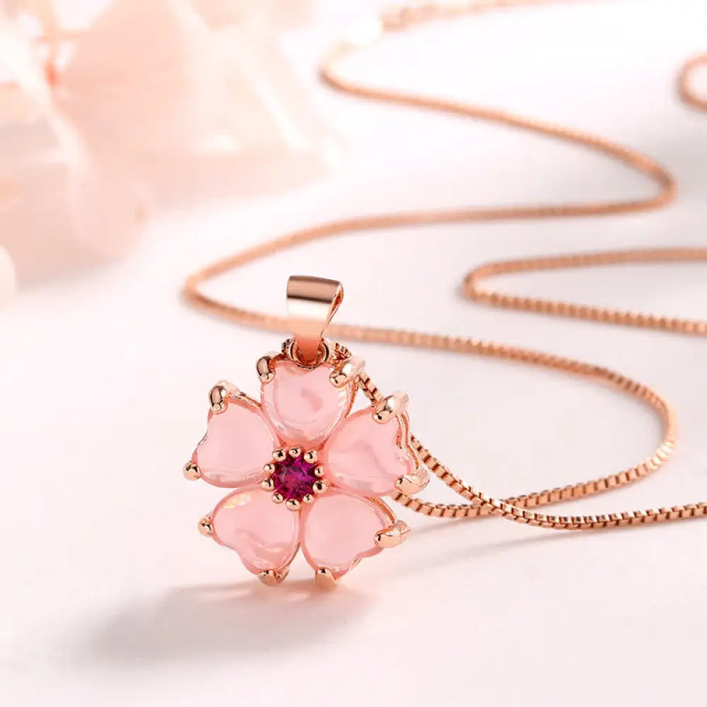 Close-up of a BWOOOH Pink Crystal Love Heart Flower pendant on a copper setting, attached to a delicate 45cm chain, showcasing its soothing warmth and self-love energy. Handcrafted 16x15mm charm.