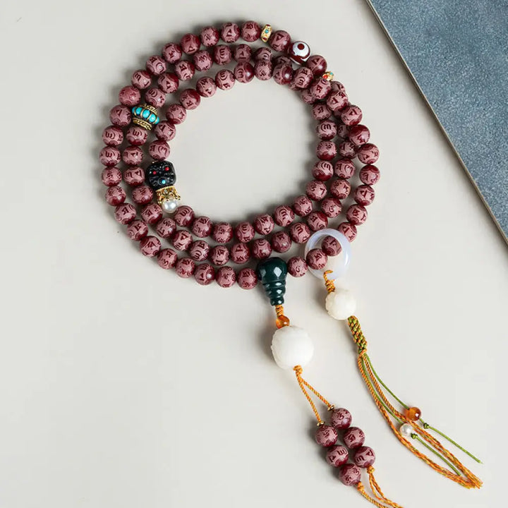 BWOOOH Red Bodhi Seed Harmony Bracelet, 10mm dark-speckled beads. Features engraved Om Mani Padme Hum mantra and Lotus symbol, accented with Liuli Glass, Pearl, Agate, Turquoise beads. Unisex design for spiritual balance and enlightenment.