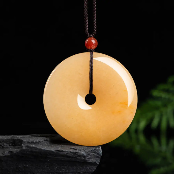 BWOOOH Round Golden Silk Jade Peace Buckle pendant necklace with natural gold veining for wealth and harmony