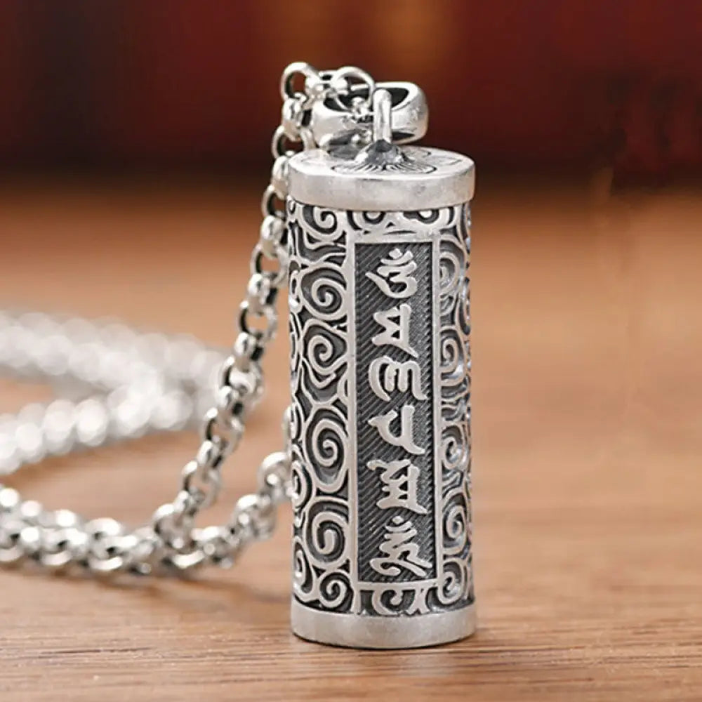 A close-up of the BWOOOH Six True Words Protection Necklace Pendant, crafted from silver plated copper, showcasing the 'Om Mani Padme Hum' mantra. The 4.1x1.4cm unisex pendant reflects spiritual wisdom and peace.