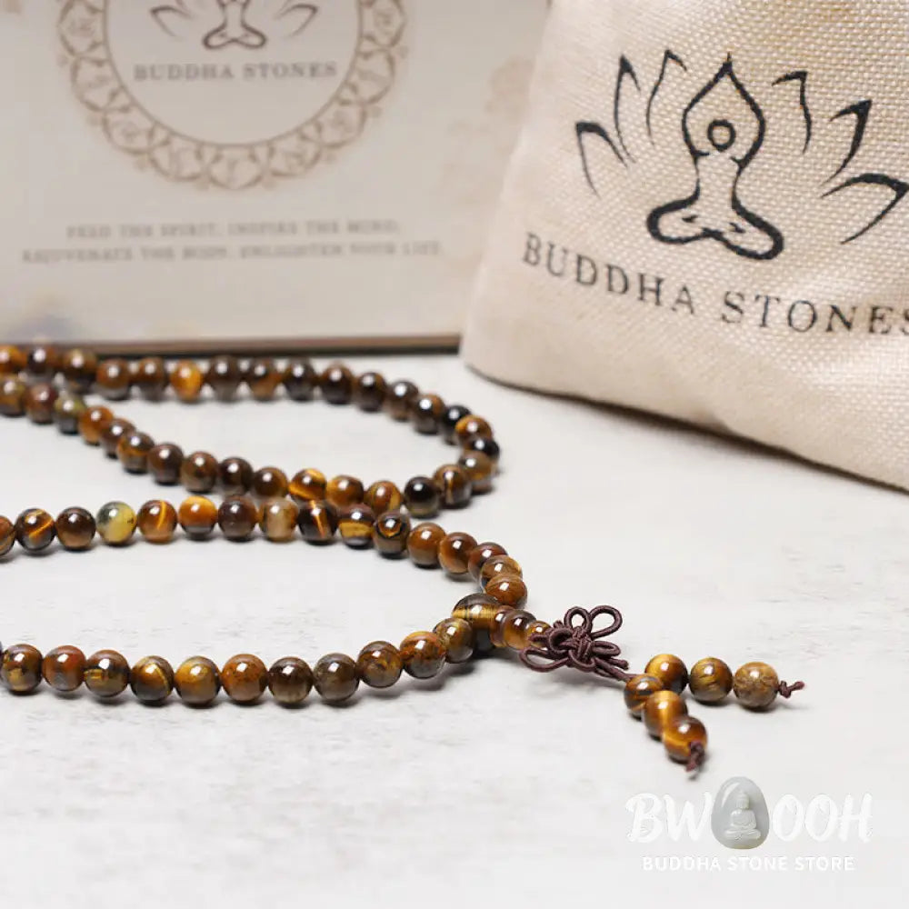 BWOOOH Tibetan 108-bead natural Tiger Eye gemstone prayer mala, handcrafted as a spiritual protection bracelet and necklace, coiled to showcase polished beads. - View 5