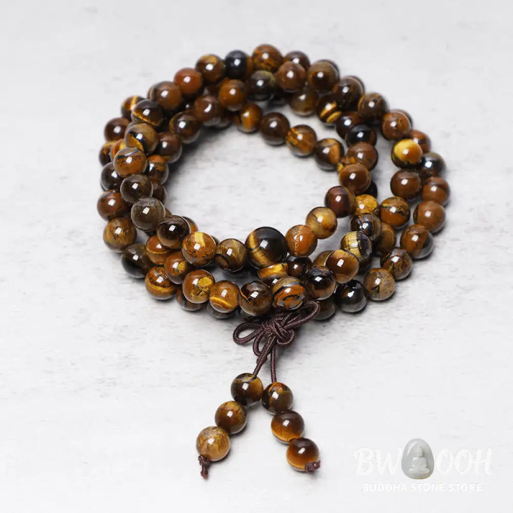 BWOOOH Tibetan 108-bead natural Tiger Eye gemstone prayer mala, handcrafted as a spiritual protection bracelet and necklace, coiled to showcase polished beads. - View 2