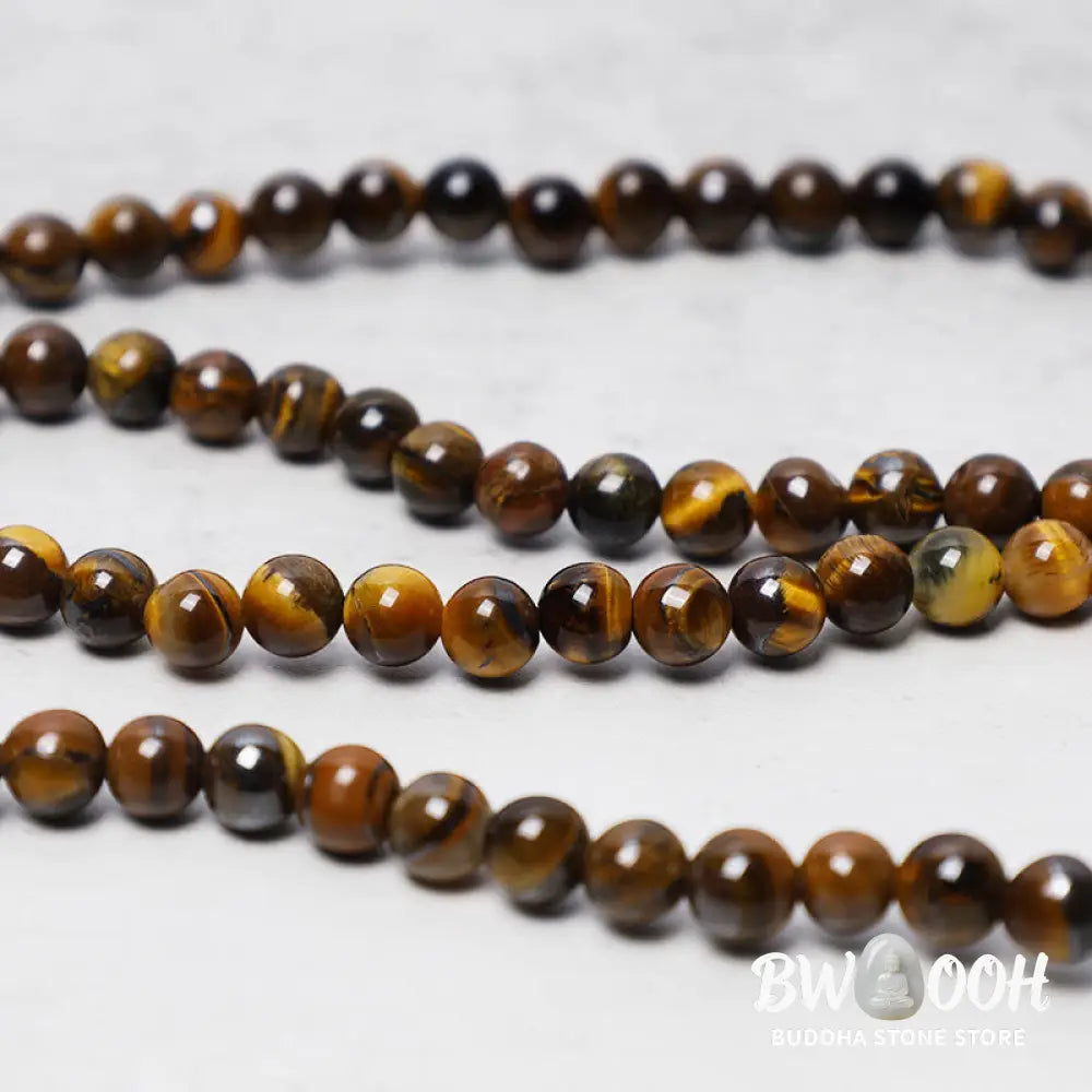 BWOOOH Tibetan 108-bead natural Tiger Eye gemstone prayer mala, handcrafted as a spiritual protection bracelet and necklace, coiled to showcase polished beads. - View 3